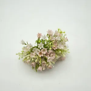 Close-up detail of artificial bellflower bouquet, pink and white floral DIY accessories.