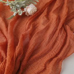 Textured crinkle cheesecloth table runner for wedding dining table decoration, elegant rustic fabric.