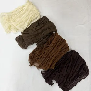 Detailed view of women's crinkle solid color long scarf voile pleated lightweight accessory.