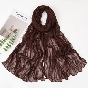 Dark brown pleated voile scarf detail, showing fine crinkled texture and lightweight summer fabric.