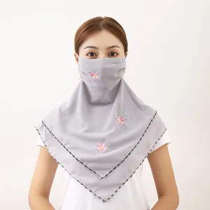 Detail shot showing the elegant floral embroidery and grey chiffon fabric of the sun-protection face mask.