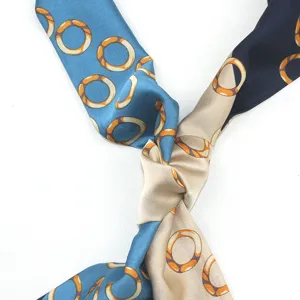 Detailed view of a narrow long silk satin ribbon scarf with geometric chain rings pattern.