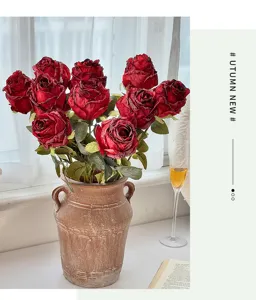 Retro burnt edge artificial rose bouquet detail shot, vintage silk flower home decor prop.