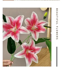 Close-up detail of 3d printed artificial lily flower with pink petals and green leaves.