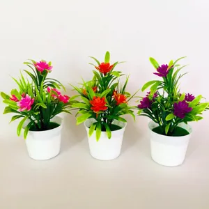 Detail view of small artificial lotus potted plants in white pots, vibrant decor bonsai.