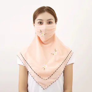 Close-up detail of the summer chiffon sun protection face mask and neck cover with embroidery.