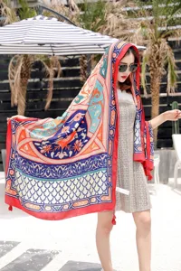 Detailed view of ethnic print beach scarf shawl, colorful bohemian pattern with tassels for travel.