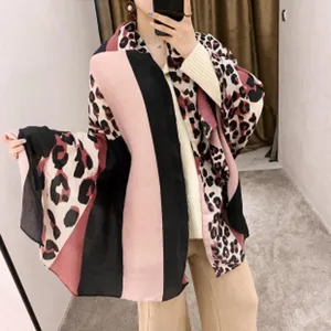 Detailed view of the leopard print color block fashion scarf showing draped fabric texture.
