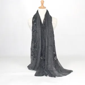Detail view of the elegant dark gray embroidered cotton linen scarf with floral motifs.