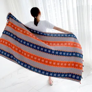 Detailed view of thick linen ethnic print beach shawl and retro scarf with fringe.