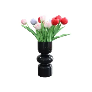 Artificial tulip flowers bouquet in black vase for modern home decor and wedding party.