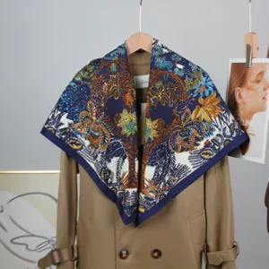 Luxury 90cm square silk scarf featuring intricate vintage floral jungle print and blue border.