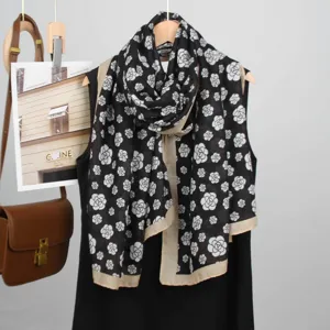 Elegant black camellia floral print scarf with beige border, stylish shawl for women.