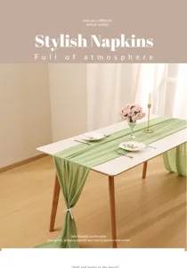 Detailed view of the elegant sage green chiffon table runner on a white banquet table