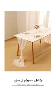 Cream chiffon table runner draped elegantly for wedding party decor.