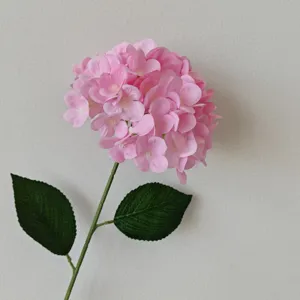 Macro view of 3D printed pink hydrangea with detailed petals and realistic green leaves