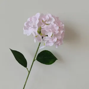Close-up of 3D printed artificial pink hydrangea flower with realistic green leaves
