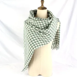 Elegant green and white houndstooth patterned scarf shown draped on a mannequin torso