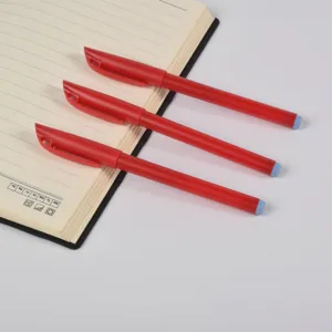 Set of three professional red office gel pens laid across a lined notebook page.