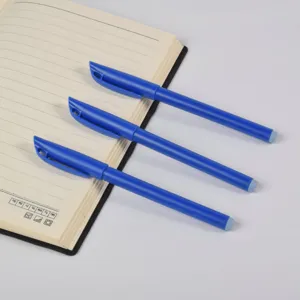 Close-up detail showing three blue business gel pens arranged neatly on an open notebook.
