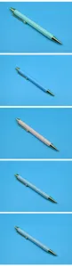 Detailed view of retractable ballpoint pens in five pastel colors on blue background