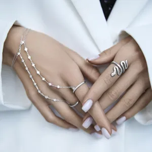Close-up of 925 sterling silver slave bracelet and snake ring with sparkling zircons