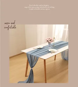 Elegant blue chiffon table runner draped gracefully over a white wooden dining table
