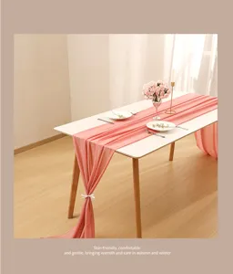 Detailed view of elegant pink chiffon table runner with soft texture for wedding decor