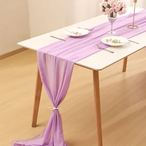 Elegant lavender chiffon table runner draped over a white table for banquet wedding decor