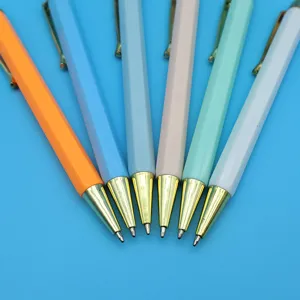 Colorful hexagonal retractable ballpoint pens with gold tips arranged in a fan