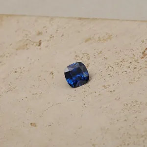 Macro view of deep blue cushion-cut cubic zirconia birthstone for DIY jewelry necklaces