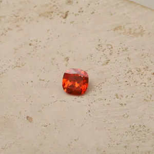 Detailed shot of an orange cushion-cut zirconia birthstone for custom necklaces