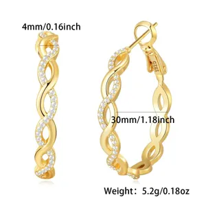 Detail view of gold twisted hoop earrings with micro-paved zirconia and S925 stamp