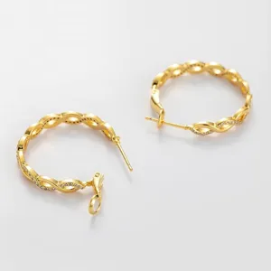Close-up of gold S925 sterling silver twisted hoop earrings with micro-pave zirconia details.