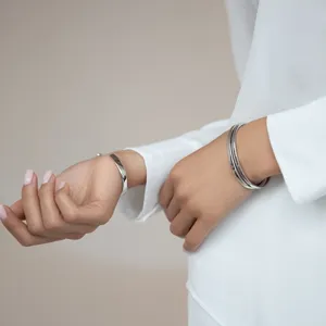 Minimalist 925 sterling silver bangles and bracelets styled with a crisp white shirt