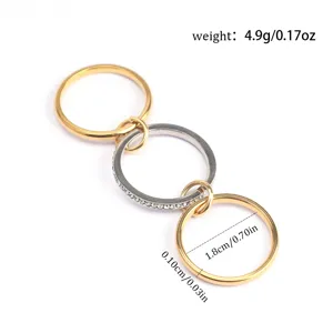 Detailed view of interconnected triple-layer titanium steel rings with measurements