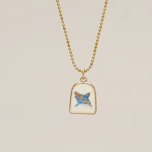 Detailed view of luminous Van Gogh Starry Night art pendant on gold bead chain necklace