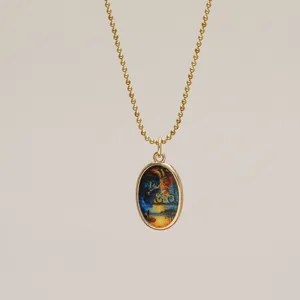 Detailed macro view of Van Gogh's Starry Night pendant on a gold ball chain necklace