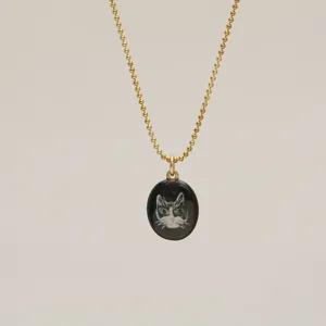 Detailed view of elegant gold bead chain necklace with hand-painted cat portrait pendant