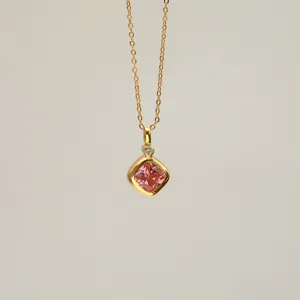 Detail showing the pink square zircon pendant and 18K gold plated chain for women.