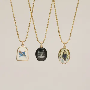 Macro detail of luminous Van Gogh Starry Night, cat, and figure pendants on gold chains