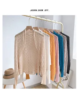 Detailed view of lightweight hollow honeycomb knit shrugs in various vibrant colors