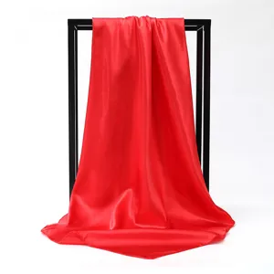 Detailed view of a vibrant red satin square scarf with a smooth and lustrous texture.