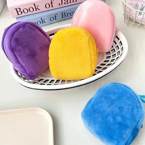 Close-up view of creative and colorful plush mini backpack coin purses in a basket