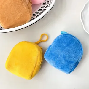 Detailed macro shot of plush mini backpack coin purses in vibrant yellow and blue colors.