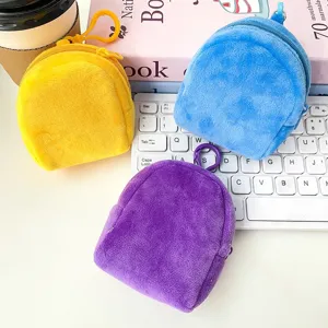 Macro view of cute mini plush backpack coin purses in yellow, blue, and purple colors