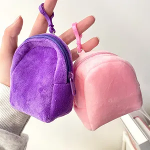 Close-up of mini plush backpack coin purses in purple and pink colors