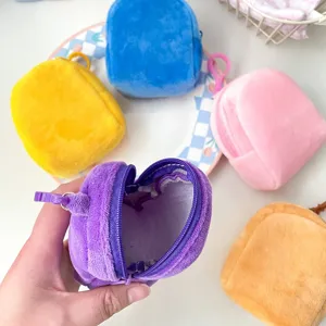 Detailed view of plush backpack coin purses showing interior and multiple colors.