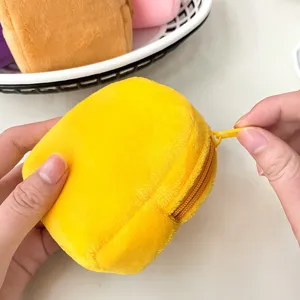 Detail showing the functional zipper on a yellow plush mini backpack coin purse