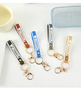 Close-up view of five colorful PVC wristband keychains with stylish scalloped edges